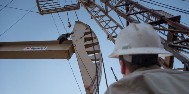 Oil field workers with Wisco work on pump jack in Tioga, N.D., Nov 6, 2013. Back in 2008 the North Dakota oil boom started its ongoing period of extraction of oil from the Bakken formation. The amount of jobs the oil boom has provided North Dakota has helped give it the lowest unemployment rate in the United States and and gave it a billion dollar surplus. Photo Ken Cedeno (Photo by Ken Cedeno/Corbis via Getty Images)
