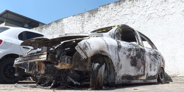 Grab taken from an AFP video showing the burned-out rental car of missing Greek ambassador to Brazil Kyriakos Amiridis, at a parking lot outside the police station in Belford Roxo, in the Brazilian state of Rio de Janeiro, on December 30, 2016, a day after it was found with a body inside.
Police have still not confirmed whether the body found in the car was that of the 59-year-old ambassador, who went missing on Monday night. / AFP / Marie HOSPITAL (Photo credit should read MARIE HOSPITAL/AFP/Getty Images)