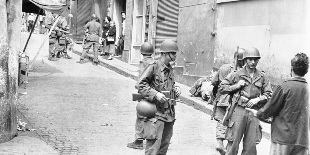 (Original Caption) French make house-to-house search in Casbah. Algiers, Algeria: French soldiers in full battle dress are shown during a house-to-house search in the Casbah, the old Moslem quarter of Algeria where some 50,000 natives live. Six thousand French soldiers made the surprise raid on the area searching for rebel arms and equipment while helicopters hovered overhead to observe any movement in the sealed off sector. More than 200 men carrying arms were arrested and 2,000 Moslems were he