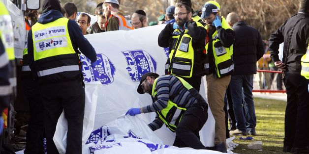 EDITORS NOTE: Graphic content / Israeli security forces and emergency personnel gather at the site of a vehicle-ramming attack in Jerusalem on January 8, 2017.
A truck ploughed into a group of soldiers in Jerusalem in what police said was a 'possible terrorist attack' in which at least four were killed and a number of people injured. / AFP / MENAHEM KAHANA (Photo credit should read MENAHEM KAHANA/AFP/Getty Images)