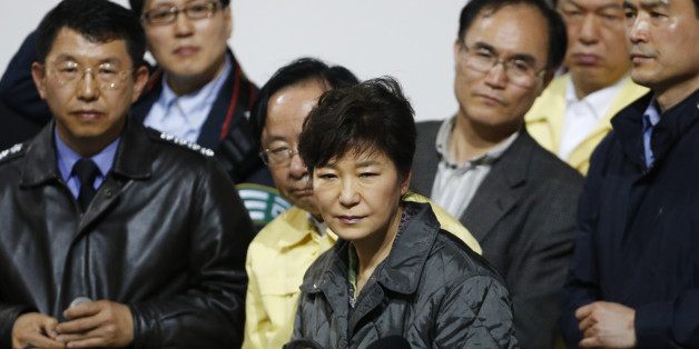South Korean President Park Geun-hye (C) listens to a family member of a missing passenger who was on South Korean ferry "Sewol", which sank at the sea off Jindo, during her visit to a gym where family members gathered, in Jindo April 17, 2014. Rescuers fought rising winds, strong waves and murky waters on Thursday as they searched for hundreds of people, mostly teenage schoolchildren, still missing after a South Korean ferry capsized more than 24 hours ago. REUTERS/Kim Hong-Ji (SOUTH KOREA -