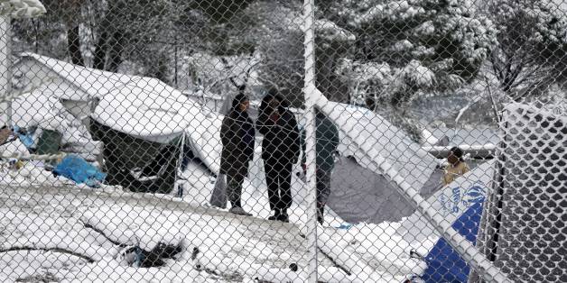 Migrants stand next to their tents at the Moria hotspot on the island of Lesbos , following heavy snowfalls on January 7, 2017.
The number of migrants arriving in Europe by two main sea routes in 2016 plunged by almost two-thirds to 364,000 compared with the previous year, EU border agency Frontex said Friday. Frontex pointed to an EU border deal with Turkey which came into effect in March as having paved the way to a massive decline in the arrival of Syrian refugees and other migrants in Greece.
/ AFP / STR (Photo credit should read STR/AFP/Getty Images)