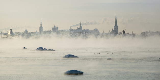Cityscape of Tallinn over the waterfront in a cold day. -18 degrees Celsuis. The sea is steaming cause of the cold outside.