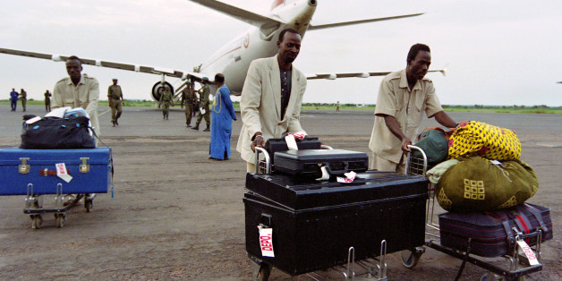 Malians deported from France arrives at Bamako airport on August 25, 1996, in Bamako. Among the group were four Malians of the 200 Africans, forcibly evicted on August 23 from a Paris church which they had occupied for more than 2 months to obtain residence papers. (Photo credit should read ISSOUF SANOGO/AFP/Getty Images)