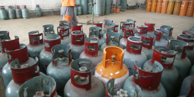 A worker carries a cylinder of Liquefied Petroleum Gas (LPG) in Foshan, Guangdong province, October 20, 2008. China is the biggest consumer of LPG, a compressed mix of propane and butane, used for heating and transport, and now increasingly being considered for making petrochemicals in the world's second-biggest economy. As demand in China soars, the U.S. shale boom has led to a surge in production of LPG, which is bringing down global prices and challenging established suppliers in the Middle E