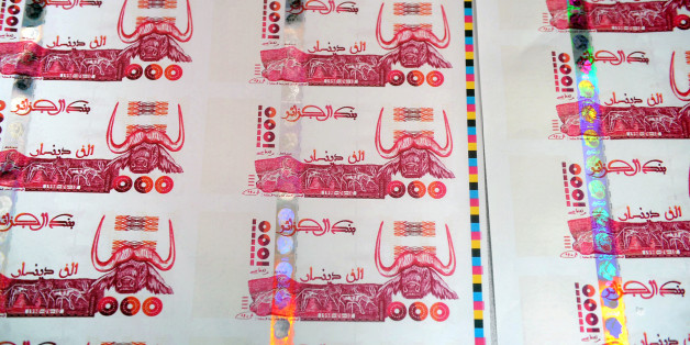 A picture taken on October 26, 2009 in Lyon, central France shows plates of false printed Algerian Dinar banknotes, shown during a press conference given after the police broke up a network of counterfeit currency. Twelve people were jailed and indicted on October 25, but the network has already used at least 200,000 banknotes of 1,000 dinars, or nearly 2 million Euros, said judicial police. AFP PHOTO PHILIPPE MERLE (Photo credit should read PHILIPPE MERLE/AFP/Getty Images)