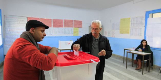 A Tunisian man casts his ballot in the capital Tunis December 21, 2014. Tunisians began voting on Sunday in a presidential run-off election that completes the country's last steps to full democracy nearly fours years after an uprising that toppled autocrat Zine El-Abidine Ben Ali. REUTERS/Anis Mili (TUNISIA - Tags: ELECTIONS POLITICS)