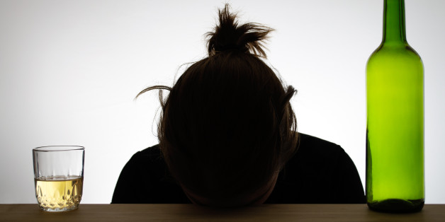 Alcoholic woman's silhouette with a wine bottle and a glass of wine