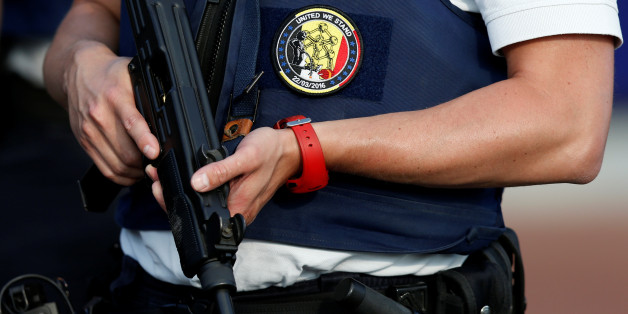 A Belgian police officer stands guard outside the main police station after a machete-wielding man injured two female police officers before being shot in Charleroi, Belgium, August 6, 2016. The badge on the vest bears the date of the March 22 attacks in Brussels. REUTERS/Francois Lenoir TPX IMAGES OF THE DAY