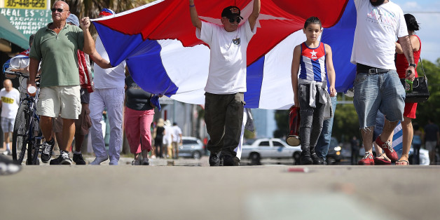MIAMI, FL - NOVEMBER 26: People hold a Cuban flag in the streets as they react to the news of the death of former Cuban President Fidel Castro outside the restaurant Versailles on November 26, 2016 in Miami, Florida. Many, mostly Cubans, gathered to wave flags and celebrate the news of the death of the Cuban revolutionary who died at 90. (Photo by Joe Raedle/Getty Images)