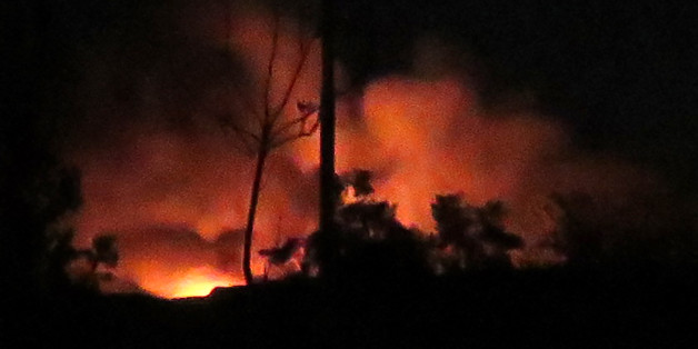 A general view shows flames and smoke at the Mezzah military airport on the southwestern outskirts of the capital Damascus following an explosion early on January 13, 2017. The Syrian army said that Israeli missile strikes caused a series of explosions at an airbase outside Damascus before dawn. The Israeli army had no comment on the strikes when contacted by AFP earlier on January 13, 2017. / AFP / - (Photo credit should read -/AFP/Getty Images)