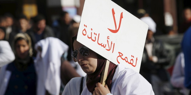 A demonstrator holds a sign as she takes part in a demonstration in the city of Casablanca, on February 25, 2016. Teachers protest through the streets against the two new decrees reducing their stipends and job security during a demonstration organised by trainee teachers. The sign reads, "Do not persecute teachers". REUTERS/Youssef Boudlal