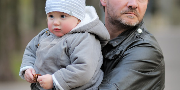 Middle age father with his toddler son walking outdoors / kidnapping concept