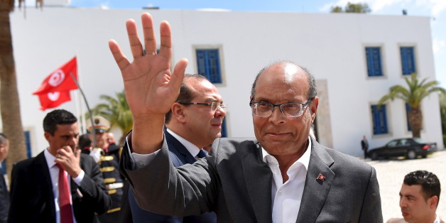 Former Tunisian president Moncef Marzouki arrives to take part in an anti-extremism march in Tunis March 29, 2015. World leaders joined tens of thousands of Tunisians on Sunday to march in solidarity against Islamist militants, a day after security forces killed members of a group blamed for a deadly museum attack. REUTERS/Emmanuel Dunand/Pool