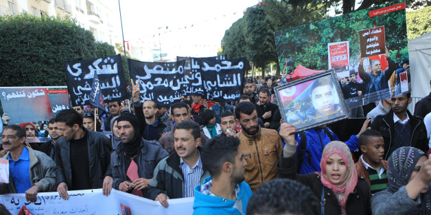 TUNIS, TUNISIA - JANUARY 14: The families of the victims and wounded of the Tunisian revolution hold banners at the Habib Bourguiba street at the 4th anniversary of the January 14 revolution, in Tunis on January 14,2015. (Photo by Yassine Gaidi/Anadolu Agency/Getty Images)
