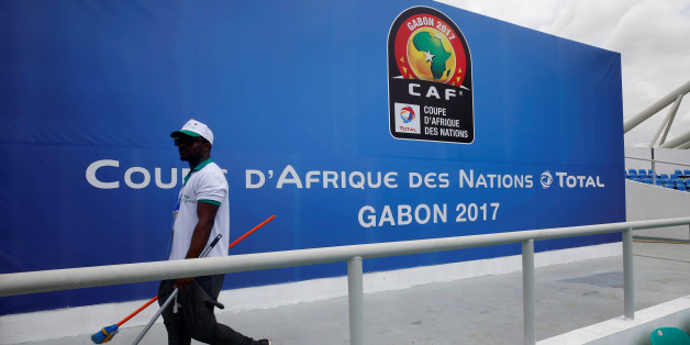 A worker walks past a billboard at the Stade de l'Amitie Sino ahead of the African Nations Cup Soccer Tournament in Libreville, Gabon, January 13, 2017. REUTERS/Mike Hutchings