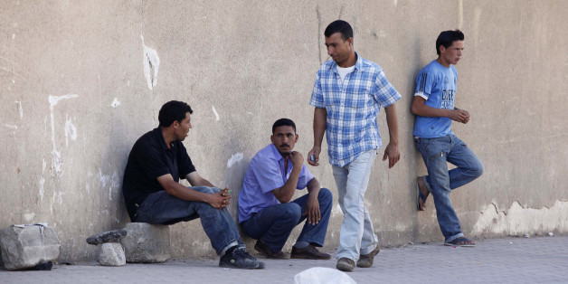 Men wait for casual work offers on a street of Cheraga, west of Algiers, June 24, 2010. Local officials say that Islamist insurgents, fighting a lingering conflict with Algeria's security forces, are targeting small armies of unemployed young men and persuading some of them to join their ranks across Algeria. To match Feature SECURITY-QAEDA/ALGERIA REUTERS/Louafi Larbi (ALGERIA - Tags: CIVIL UNREST POLITICS)