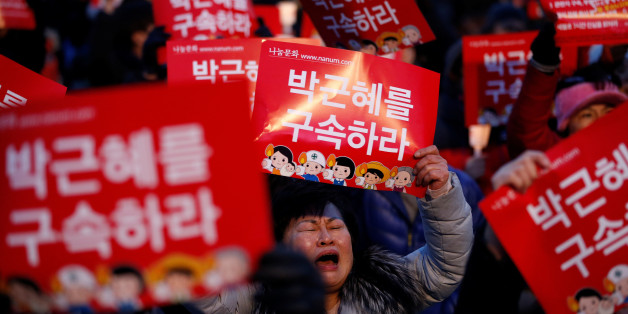People attend a protest demanding South Korean President Park Geun-hye's resignation in Seoul, South Korea December 17, 2016. The signs read "Arrest Park Geun-hye". REUTERS/Kim Hong-Ji