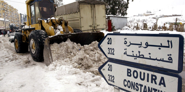 A tractor clears the snow off the road on the outskirts of the Algerian capital Algiers, January 27,2005, as the heaviest snow in more than 50 years fell on Thursday. Several areas in the north, in particular the Mediterranean oil port city of Skikda, were cut off after two days of snow, strong winds and rain. In the last 24 hours 13 people have died and 47 others have been injured, mostly in road accidents. REUTERS/ Louafi Larbi DL/DL