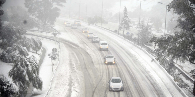 Cars drive on snow on February 4, 2012 on a highway on the outskirts of Algiers after a snowfall. AFP PHOTO / FAROUK BATICHE (Photo credit should read FAROUK BATICHE/AFP/Getty Images)