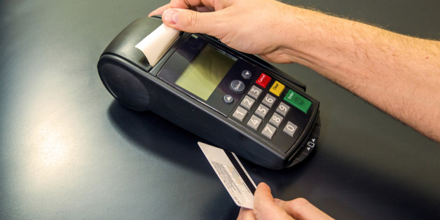 Male hand dials pin code on pin pad of card machine or pos terminal with inserted blank white credit card isolated on white background. Payment with credit card - businessman holding pos terminal.