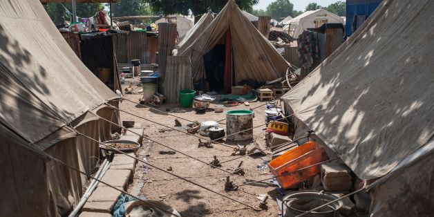 A picture taken on December 8, 2016 shows tents at the Internally Displaced People (IDP) camp, in Bama.The houses are burnt-out shells, and charred cars and petrol pumps line the roads in the once-bustling Nigerian trade hub of Bama before it was razed by Boko Haram jihadists, know 85% is destroyed. The camp now houses a little over 10,000 people who either escaped or survived the seven months under Boko Haram rule. The conflict with Boko Haram in northeast Nigeria has displaced more than 2.6 mi