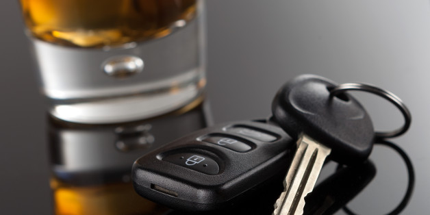 Alcoholic Drink resting next to a pair of car keys. Please do not drink and drive