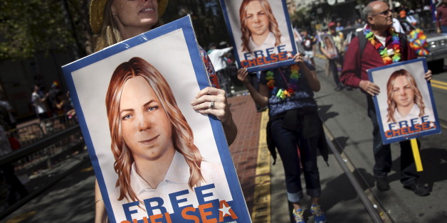 People hold signs calling for the release of imprisoned wikileaks whistleblower Chelsea Manning while marching in a gay pride parade in San Francisco, California June 28, 2015. Manning has appealed to an Army court to overturn her court-martial conviction, a court filing released on Thursday said. REUTERS/Elijah Nouvelage/File Photo