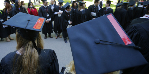 Graduating students wear red tape on their caps in solidarity with victims of sexual abuse during the 363rd Commencement Exercises at Harvard University in Cambridge, Massachusetts May 29, 2014. REUTERS/Brian Snyder (UNITED STATES - Tags: EDUCATION)