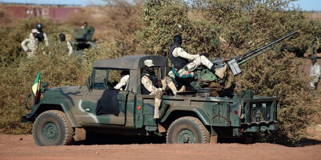 FAMA (Armed and Security Forces of Mali) servicemen stand guard on a military vehicle, as part of a visit of French President to the troops of France's Barkhane counter-terrorism operation in Africa's Sahel region in Gao, northern Mali, on January 13, 2017.Talks gathering some 30 African states and France begin in Mali's capital Bamako on January 13, with leaders expected to focus on Africa's battle against jihadists and bid to improve its democratic record. / AFP / STEPHANE DE SAKUTIN (P