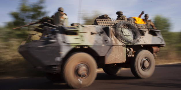 French troops ride on an amoured vehicle on a road near the frontline in their conflict with Islamists just outside Niono, January 19, 2013. France called on Saturday on other world powers to commit money and logistical support for African armies readying their troops to join French soldiers already battling al Qaeda-linked militants in Mali. REUTERS/Joe Penney (MALI - Tags: CIVIL UNREST MILITARY CONFLICT)