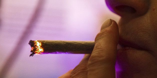 A Dutch woman smokes a cannabis cigarette in a coffee shop in Amsterdam October 6, 2011. Coffee shops in the Netherlands were left wondering on Saturday how to comply with restrictions announced by the Dutch government on the sale of "strong" cannabis, saying enforcement would be difficult given the laws on production. The coalition government said it would seek to ban what it considered to be highly potent forms of cannabis, "skunk", placing them in the same category as hard drugs such as heroin or cocaine. Picture taken October 6, 2011. To match story DUTCH-CANNABIS/ REUTERS/Toussaint Kluiters (NETHERLANDS - Tags: DRUGS SOCIETY POLITICS CRIME LAW)