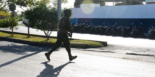 A marine arrives at the place where a shooting erupted after an attack against the building of the Quintana Roo State Prosecution, in Cancun, Mexico, on January 17, 2017.
The shooting happened as Mexican authorities investigate whether a feud over local drug sales was behind a nightclub shooting that killed three foreigners and two Mexicans at a popular beach resort. Monday's shooting at the Blue Parrot club during the BPM electronic music festival rocked Playa del Carmen, a usually peaceful Caribbean seaside town. / AFP / STR (Photo credit should read STR/AFP/Getty Images)
