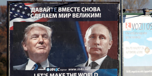 Pedestrians cross the street behind a billboard showing a pictures of US president-elect Donald Trump and Russian President Vladimir Putin in Danilovgrad, Montenegro, November 16. 2016. REUTERS/Stevo Vasiljevic