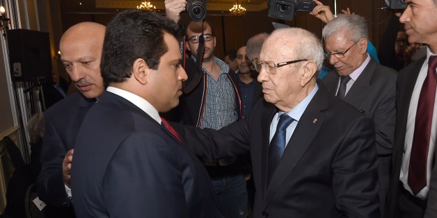 Tunisian newly-elected President Beji Caid Essebsi (C) greets the leader of the Free Patriotic Union (UPL) and former presidential candidate Slim Riahi (L) as part of a meeting with political parties who supported him on December 24, 2014 in Tunis. Essebsi said the day before that the country has turned the page on dictatorship after a presidential vote that European observers hailed as 'credible and transparent'. AFP PHOTO / FETHI BELAID (Photo credit should read FETHI BELAID/AFP/Getty Images)