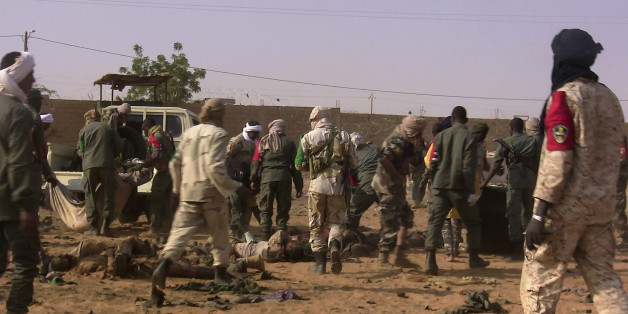 EDITORS NOTE: Graphic content / The dead and injured are evacuated following a suicide bomb attack that ripped through a camp grouping former rebels and pro-government militia in Gao, in the troubled northern Mali left 50 people dead on January 18, 2017 in Gao.Malian president's office ordered three days of national mourning following the attack, the worst in the country in recent years. / AFP / STRINGER (Photo credit should read STRINGER/AFP/Getty Images)