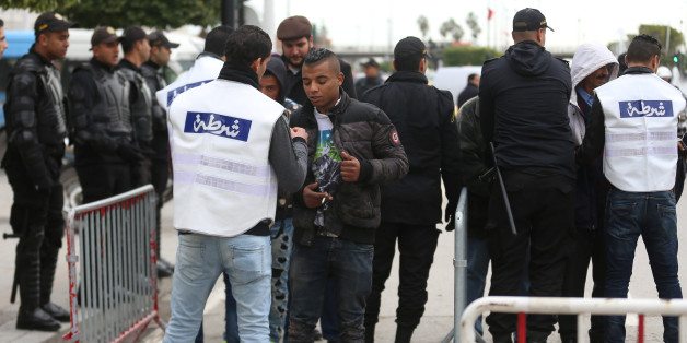 Police officers conduct security checks at the entrance of Habib Bourguiba Avenue during celebrations marking the sixth anniversary of Tunisia's 2011 revolution in Tunis, Tunisia January 14, 2017. REUTERS/Zoubeir Souissi