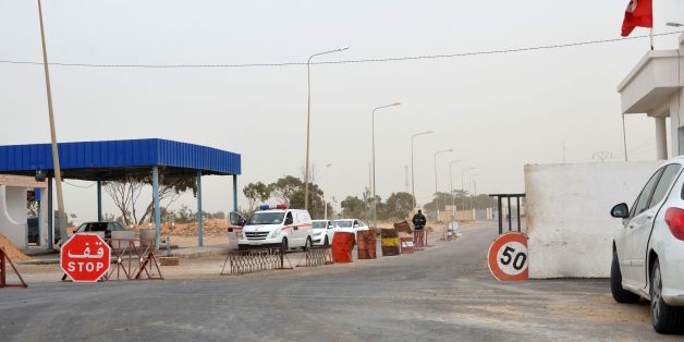 A picture taken on March 22, 2016 shows vehicles waiting near the Tunisian customs post at the Ras Jedir border crossing with Libya, south of the town of Ben Guerdane, after it was reopened after a two-week closure in response to a deadly jihadist attack on a town near the frontier.
Both the Ras Jedir crossing on the Mediterranean coast and the Dehiba crossing in the mountainous desert interior reopened at 0600 GMT, ministry spokesman Yasser Mesbah said.Tunisia closed the two crossings on March 7 when dozens of heavily armed jihadists who had slipped across the border from Libya launched coordinated attacks on police and army posts in the town of Ben Guerdane, north of Ras Jedir.
/ AFP / FATHI NASRI (Photo credit should read FATHI NASRI/AFP/Getty Images)