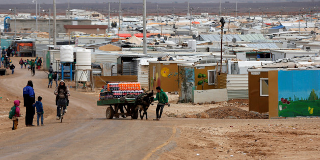 Syrian refugees are seen during rainy weather at the Al Zaatari refugee camp in the Jordanian city of Mafraq, near the border with Syria December 18, 2016. REUTERS/Muhammad Hamed