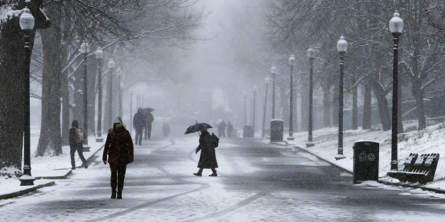 Pedestrians walk through the snow on Boston Common during a spring snow storm in Boston, Massachusetts April 4, 2016. REUTERS/Brian Snyder