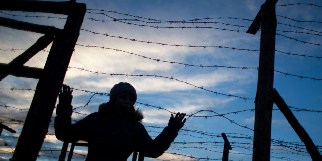 A woman stands behind remains of the border fences from the former 'Iron curtain' between Slovakia and Austria on November 20,2016 near Bratislava, Slovakia.
The bridge was symbolically closed for 3 days to remeber victims who lost their lives trying to escape the communist regime. Slovaks and Czechs commemorated on 17 of November 26th anniversary of the Velvet revolution. / AFP / VLADIMIR SIMICEK (Photo credit should read VLADIMIR SIMICEK/AFP/Getty Images)