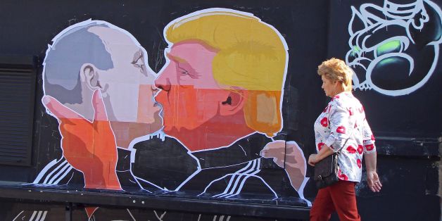 A woman walks past a mural on a restaurant wall depicting US Presidential hopeful Donald Trump and Russian President Vladimir Putin greeting each other with a kiss in the Lithuanian capital Vilnius on May 13, 2016.
Kestutis Girnius, associate professor of the Institute of International Relations and Political Science in Vilnius university, told AFP -This graffiti expresses the fear of some Lithuanians that Donald Trump is likely to kowtow to Vladimir Putin and be indifferent to Lithuanias security concerns. Trump has notoriously stated that Putin is a strong leader, and that NATO is obsolete and expensive.
/ AFP / Petras Malukas (Photo credit should read PETRAS MALUKAS/AFP/Getty Images)