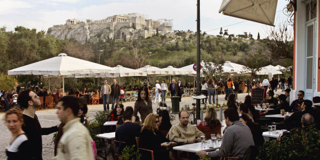 Athens, GREECE: Hundreds of Athenians and tourists enjoy their coffee and a walk in central Athens at the Acropolis walking zone Sunday afternoon, 04 March 2007 as the temperatures in the city soared to 22 Celsius degrees. AFP PHOTO/LOUISA GOULIAMAKI (Photo credit should read LOUISA GOULIAMAKI/AFP/Getty Images)