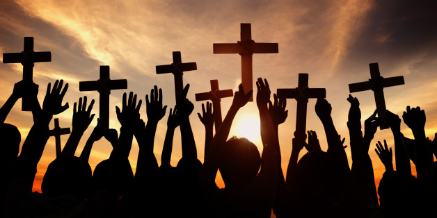 Group of People Holding Cross and Praying in Back Lit