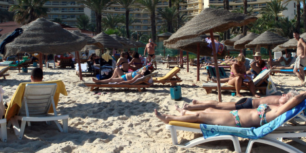 Tourists enjoy the beach near a four-star hotel in the resort town of Sousse, a popular tourist destination 140 kilometres (90 miles) south of the Tunisian capital, on October 31, 2013, one day after a failed suicide attack in the area. Tunisia, already destabilised by a political crisis, tightened security on Thursday after two failed suicide bombings that dealt a blow to the country's vital tourism industry. AFP PHOTO / BECHIR BETTAIEB (Photo credit should read BECHIR BETTAIEB/AFP/Getty Images)