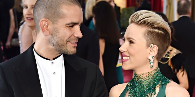 Scarlett Johansson (R) and Romain Dauriac pose on the red carpet for the 87th Oscars on February 22, 2015 in Hollywood, California. AFP PHOTO/ MLADEN ANTONOV (Photo credit should read MLADEN ANTONOV/AFP/Getty Images)