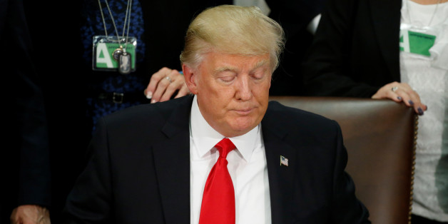 U.S. President Donald Trump reads an executive order before signing it at Homeland Security headquarters in Washington, U.S., January 25, 2017. REUTERS/Jonathan Ernst