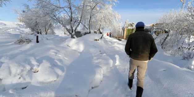 A man walks on a road covered with snow in the village of Medea, 100km south of Algiers, on February 14, 2012. Access to the villages around Medea have been cut since last week because of the snow. A cold weather spell has killed at least 44 people in Algeria over the past week, sparking strong press criticism of what it sees as the government's poor response to the emergency situation. AFP PHOTO / FAROUK BATICHE (Photo credit should read FAROUK BATICHE/AFP/Getty Images)