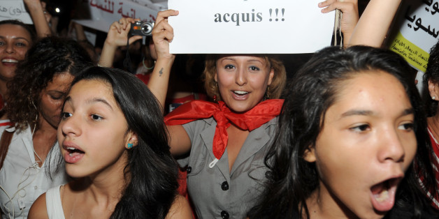 A Tunisian demonstrator shouts slogans and holds a poster reading, 'don't touch my rights' during a protest calling for the respect of women's rights and other fundemental rights on August 13, 2012 in Tunis. Tunisian women are rising up against a proposed article in the new constitution being drafted by the National Constituent Assembly seen by many as an Islamist ploy to reverse the principle of gender equality that made Tunisia a beacon of modernity in the Arab world when it was introduced six