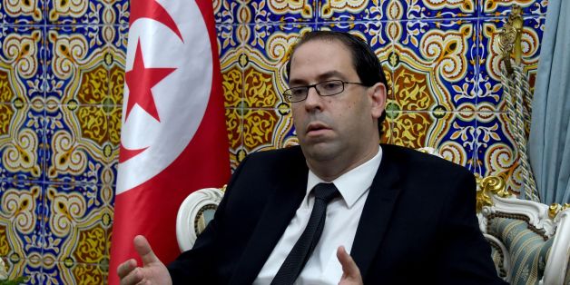 Tunisia's premier-designate Youssef Chahed sits in his office before giving a press conference to present his proposed new unity government list after he submitted it to the president on August 20, 2016 in Carthage, near the capital Tunis.
Chahed, a 40-year-old former local affairs minister and member of the Nidaa Tounes party, had been given 30 days to form a cabinet. If his cabinet wins the backing of parliament, Chahed will become the North African country's youngest premier since independence from France in 1956.
/ AFP / FETHI BELAID (Photo credit should read FETHI BELAID/AFP/Getty Images)